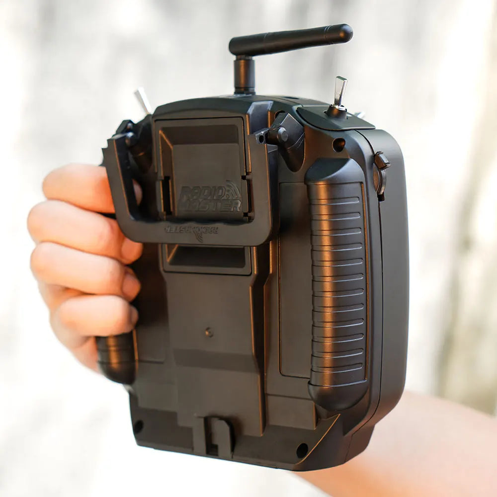 RadioMaster TX12 MKII held in one hand, showing rear grips and module bay