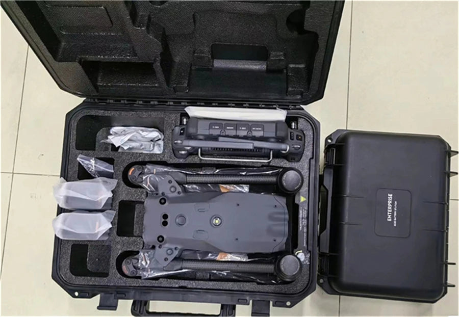 DJI Matrice 30T folded in an open carrying case beside a second hard case