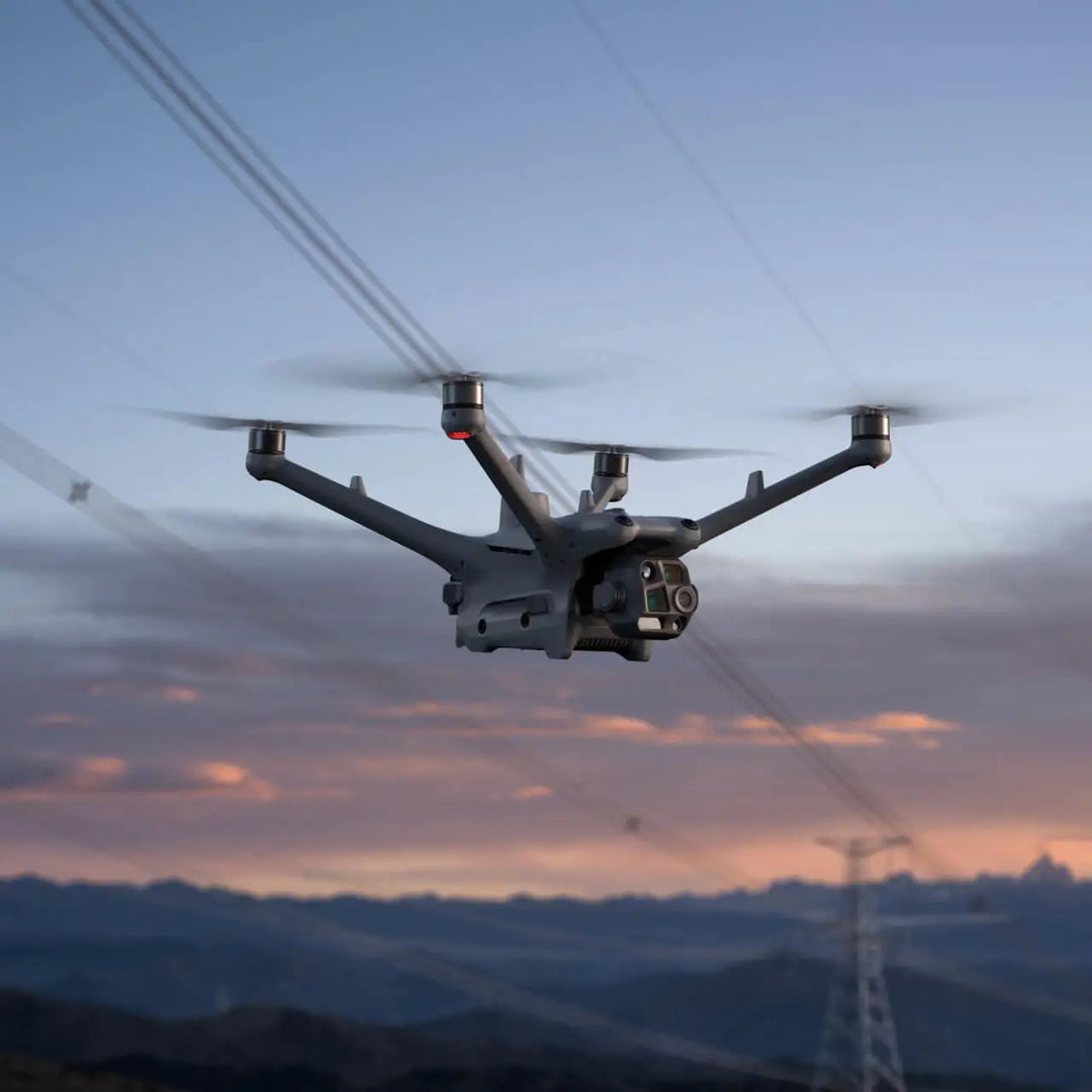 DJI Matrice 4TD flying beside power lines at dusk